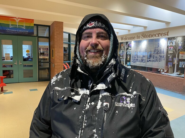 School custodian covered in snow and ice